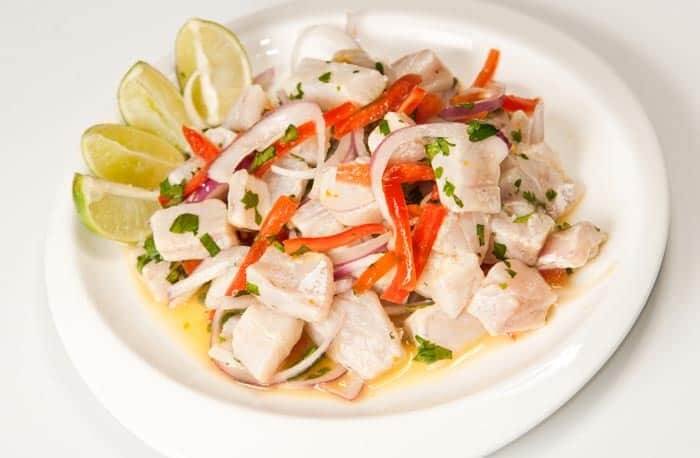 A plate with peruvian ceviche and lemon