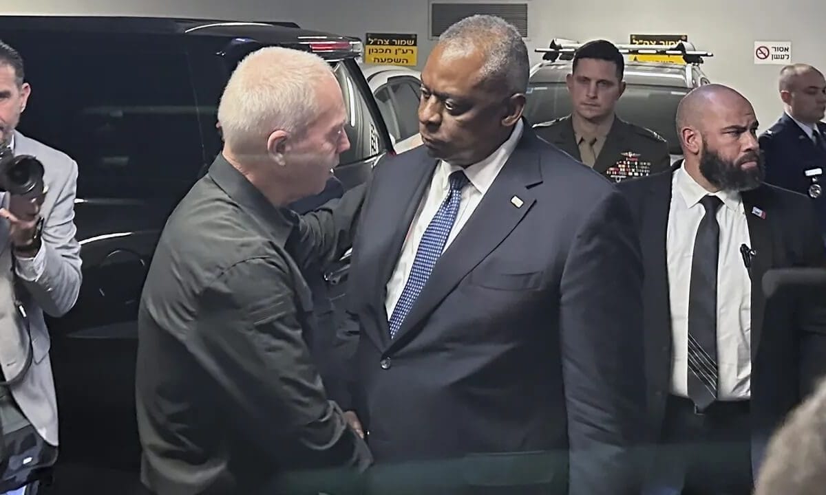 U.S. Defense Secretary Lloyd Austin is greeted by his Israeli counterpart Yoav Gallant upon his arrival at the Defense Ministry