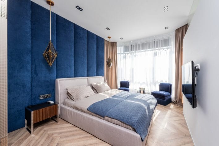 Contemporary bedroom with blue walls and big bed